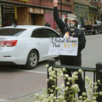 protestor holds sign